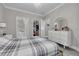 Well-lit bedroom with grey wood floors, a decorative light fixture, and a walk in closet at 2722 Via Tivoli # 430A, Clearwater, FL 33764