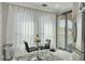 Bright breakfast nook with modern furnishings next to a bright window and door to the exterior at 2722 Via Tivoli # 430A, Clearwater, FL 33764
