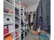 Walk-in closet with custom shelving providing ample storage and organization space for clothing and accessories at 2722 Via Tivoli # 430A, Clearwater, FL 33764