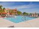 Resort-style pool features ample seating, tiled pool, and a view of the community building at 2722 Via Tivoli # 430A, Clearwater, FL 33764