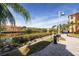 Scenic community view of a picturesque waterfront promenade with lush landscaping and nearby buildings at 2722 Via Tivoli # 430A, Clearwater, FL 33764
