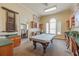 Bright game room featuring a pool table, built-in bookcases, and abundant natural light at 2722 Via Tivoli # 430A, Clearwater, FL 33764