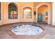 Community hot tub with tile surround, entry railing, and nearby pool area at 2722 Via Tivoli # 430A, Clearwater, FL 33764