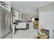 Bright kitchen with stainless steel appliances, a wine rack, white cabinetry, and modern decor at 2722 Via Tivoli # 430A, Clearwater, FL 33764