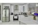 Bright kitchen featuring white cabinetry, stainless steel appliances, and a white marble backsplash at 2722 Via Tivoli # 430A, Clearwater, FL 33764
