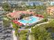 A beautiful community pool with red canopies and ample lounge seating at 2722 Via Tivoli # 430A, Clearwater, FL 33764