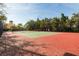 Well-maintained tennis court surrounded by trees, offering a great space for recreation at 2722 Via Tivoli # 430A, Clearwater, FL 33764