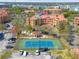 Aerial view of community tennis court alongside attractive apartment buildings at 2722 Via Tivoli # 430A, Clearwater, FL 33764