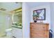 Well-lit bathroom featuring a shower, commode, and vanity with granite counters at 29230 Bay Hollow Dr # 3274, Wesley Chapel, FL 33543