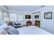 Bright bedroom featuring bright, shuttered windows, a comfy chair, and a TV at 29230 Bay Hollow Dr # 3274, Wesley Chapel, FL 33543