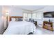 Relaxing bedroom featuring bright, shuttered windows, a comfy chair, and a TV at 29230 Bay Hollow Dr # 3274, Wesley Chapel, FL 33543