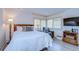 Relaxing bedroom featuring bright, shuttered windows, a comfy chair, and a TV at 29230 Bay Hollow Dr # 3274, Wesley Chapel, FL 33543