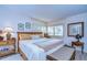 Tastefully furnished bedroom with a wicker bench seat and bright windows at 29230 Bay Hollow Dr # 3274, Wesley Chapel, FL 33543
