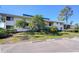 Inviting two-story condominium complex featuring a parking area and lush landscaping at 29230 Bay Hollow Dr # 3274, Wesley Chapel, FL 33543