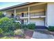 Condominium complex with covered walkways, black railings, and well-maintained landscaping at 29230 Bay Hollow Dr # 3274, Wesley Chapel, FL 33543