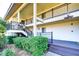 Exterior view of the condominium complex featuring covered walkways with black railings and lush landscaping at 29230 Bay Hollow Dr # 3274, Wesley Chapel, FL 33543