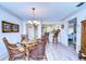 Bright dining area with a round glass table and wicker chairs, steps away from an adjacent breakfast bar at 29230 Bay Hollow Dr # 3274, Wesley Chapel, FL 33543