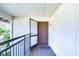 Exterior view of the condo entrance with a brown front door and gray welcome mat at 29230 Bay Hollow Dr # 3274, Wesley Chapel, FL 33543