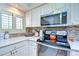 Charming kitchen featuring white cabinets, marble countertops, and stainless steel appliances at 29230 Bay Hollow Dr # 3274, Wesley Chapel, FL 33543