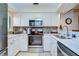 Bright kitchen with stainless steel appliances, white cabinets, and mosaic tile backsplash at 29230 Bay Hollow Dr # 3274, Wesley Chapel, FL 33543