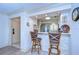 Stylish kitchen with counter seating, stainless appliances, and warm lighting, adjacent to the home's entry at 29230 Bay Hollow Dr # 3274, Wesley Chapel, FL 33543