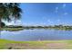 Scenic view of the tranquil lake, featuring a clear blue sky with scattered clouds at 29230 Bay Hollow Dr # 3274, Wesley Chapel, FL 33543