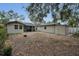 Wide shot of the backyard featuring a building and a detached storage shed at 306 S Highland Ave, Clearwater, FL 33755