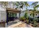 Backyard seating featuring covered swing with view of maintained flower beds and perimeter fencing at 3089 Enisglen Dr, Palm Harbor, FL 34683