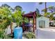 Backyard outdoor kitchen area featuring built-in BBQ, a water feature, and well maintained landscape at 3089 Enisglen Dr, Palm Harbor, FL 34683