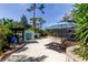 Backyard of home featuring a concrete patio, seating area with umbrella, and outdoor kitchen area at 3089 Enisglen Dr, Palm Harbor, FL 34683