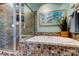 Bathroom featuring soaking tub, walk-in shower, and colorful mosaic tile at 3089 Enisglen Dr, Palm Harbor, FL 34683