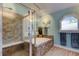 Inviting bathroom showcasing a walk-in shower and soaking tub with decorative tile surround at 3089 Enisglen Dr, Palm Harbor, FL 34683