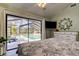 Bedroom featuring a view to the pool, a ceiling fan and a dresser at 3089 Enisglen Dr, Palm Harbor, FL 34683