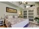 This bright bedroom includes decor above the closet and a white bed frame and bedside tables at 3089 Enisglen Dr, Palm Harbor, FL 34683