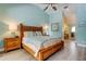 Comfortable bedroom with wood furnishings, a ceiling fan, and ensuite bathroom access at 3089 Enisglen Dr, Palm Harbor, FL 34683