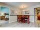 Cozy breakfast nook with wooden table and seating, bright lighting, and decorative artwork at 3089 Enisglen Dr, Palm Harbor, FL 34683