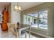 Dining area with views of screened pool and patio, natural light, and stylish fixtures at 3089 Enisglen Dr, Palm Harbor, FL 34683
