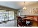 Casual dining area with table, chairs and bench seating overlooking the pool at 3089 Enisglen Dr, Palm Harbor, FL 34683