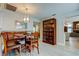 Cozy dining area features seating, wood-look floors and a decorative cabinet at 3089 Enisglen Dr, Palm Harbor, FL 34683