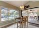 Bright dining area features pool views via a large window, and a modern hanging light fixture at 3089 Enisglen Dr, Palm Harbor, FL 34683