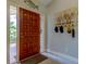 Welcoming entryway featuring a wood door and stylish decor at 3089 Enisglen Dr, Palm Harbor, FL 34683
