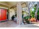 Charming front porch with brick accents and views of the meticulously landscaped yard at 3089 Enisglen Dr, Palm Harbor, FL 34683