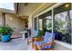 Cozy front porch featuring comfortable seating and a view of the lush garden at 3089 Enisglen Dr, Palm Harbor, FL 34683