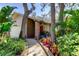 Beautifully landscaped walkway leads to the front door of this charming home at 3089 Enisglen Dr, Palm Harbor, FL 34683