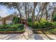 Beautifully landscaped front yard enhances the curb appeal of this lovely home at 3089 Enisglen Dr, Palm Harbor, FL 34683