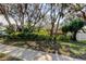 Charming home with mature trees and lush landscaping creating a serene setting at 3089 Enisglen Dr, Palm Harbor, FL 34683