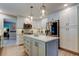 Well-lit kitchen featuring a center island, stainless steel appliances, and white cabinetry at 3089 Enisglen Dr, Palm Harbor, FL 34683