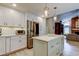 Open concept kitchen with center island, stainless steel appliances, and white cabinets at 3089 Enisglen Dr, Palm Harbor, FL 34683