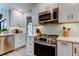 Bright kitchen featuring stainless steel appliances, and white cabinets at 3089 Enisglen Dr, Palm Harbor, FL 34683