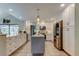 Bright kitchen with stainless steel appliances, white cabinets, and center island with pendant lighting at 3089 Enisglen Dr, Palm Harbor, FL 34683